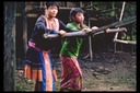 Hmong girls operating grist mill, Bua Chan, Thailand, 1986