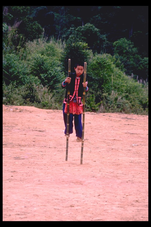 Hmong boy on bamboo stilts, Thailand, 1986
